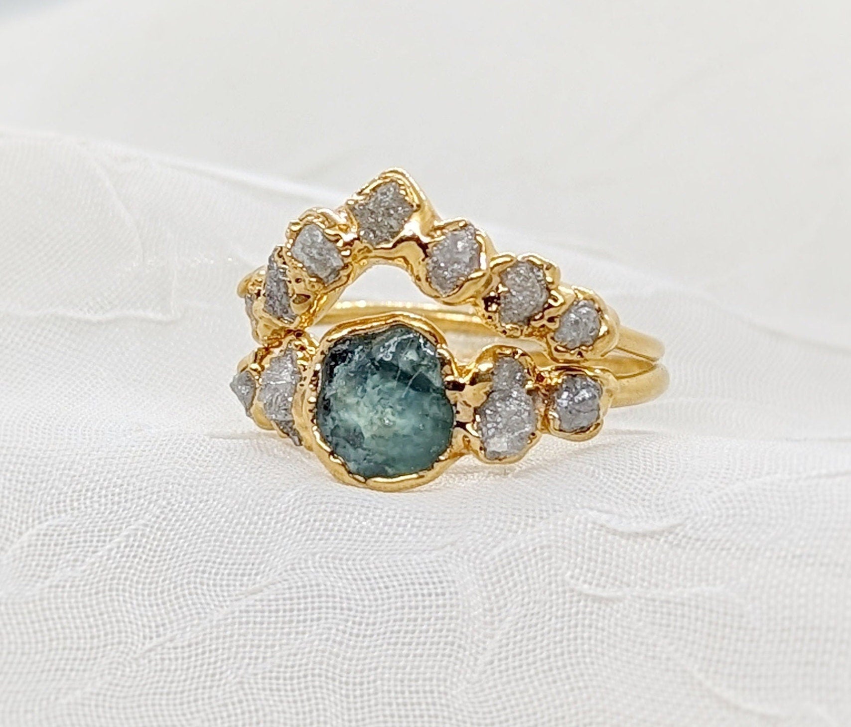 Raw Montana Sapphire and diamond wedding ring set on a solid 14k gold chevron band, uniquely handcrafted.