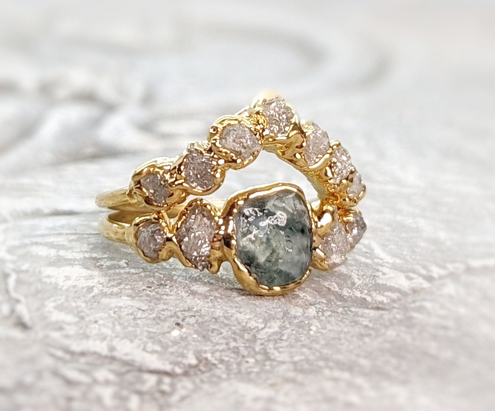 Raw Montana Sapphire and diamond ring set on a gold chevron band, unique wedding jewelry piece.