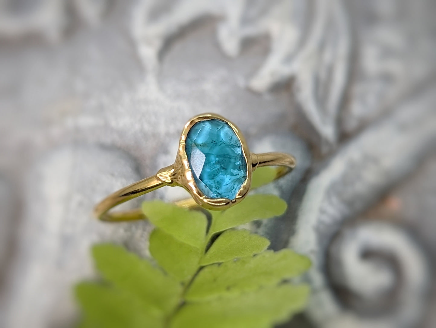 Blue tourmaline ring on a gold band, featuring a natural rose cut gemstone, ideal for gifts on special occasions.
