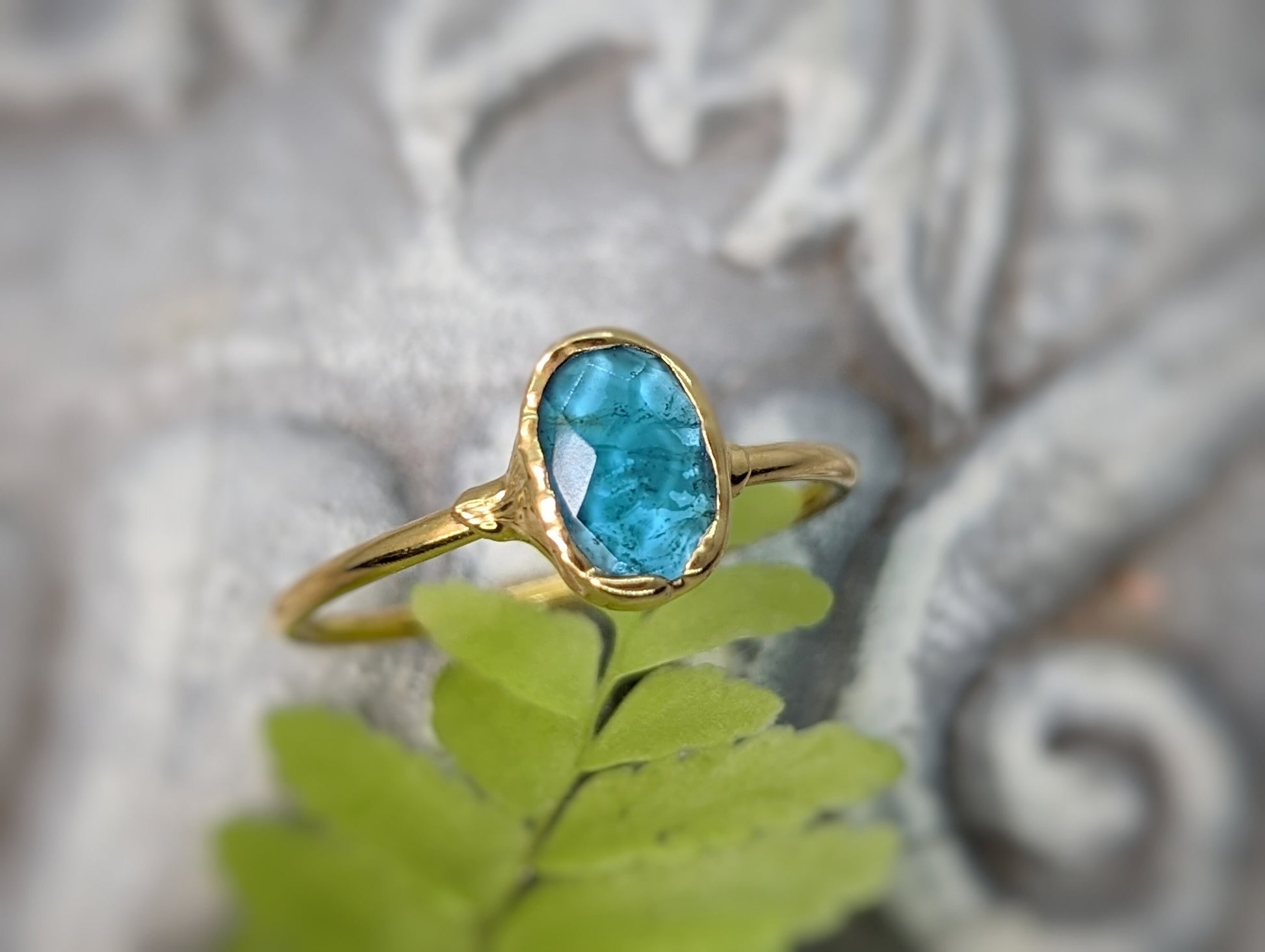 Blue tourmaline ring on a gold band, featuring a natural rose cut gemstone, ideal for gifts on special occasions.
