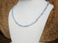 Handmade aquamarine bead necklace with golden accents, showcasing a soft blue hue and natural gemstones.