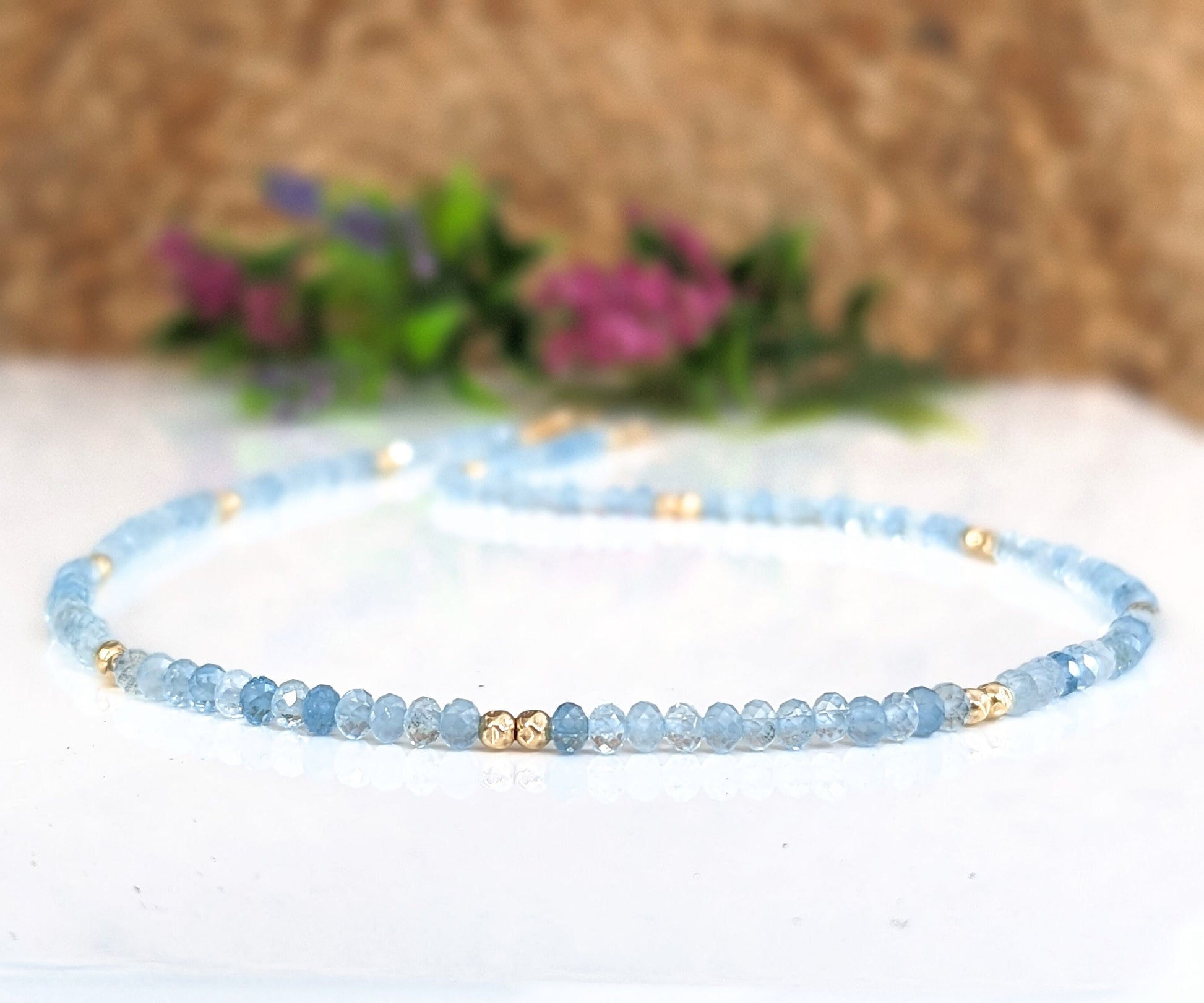 Handmade aquamarine bead necklace with gold accents, symbolizing calmness and loyalty, perfect for gifts.