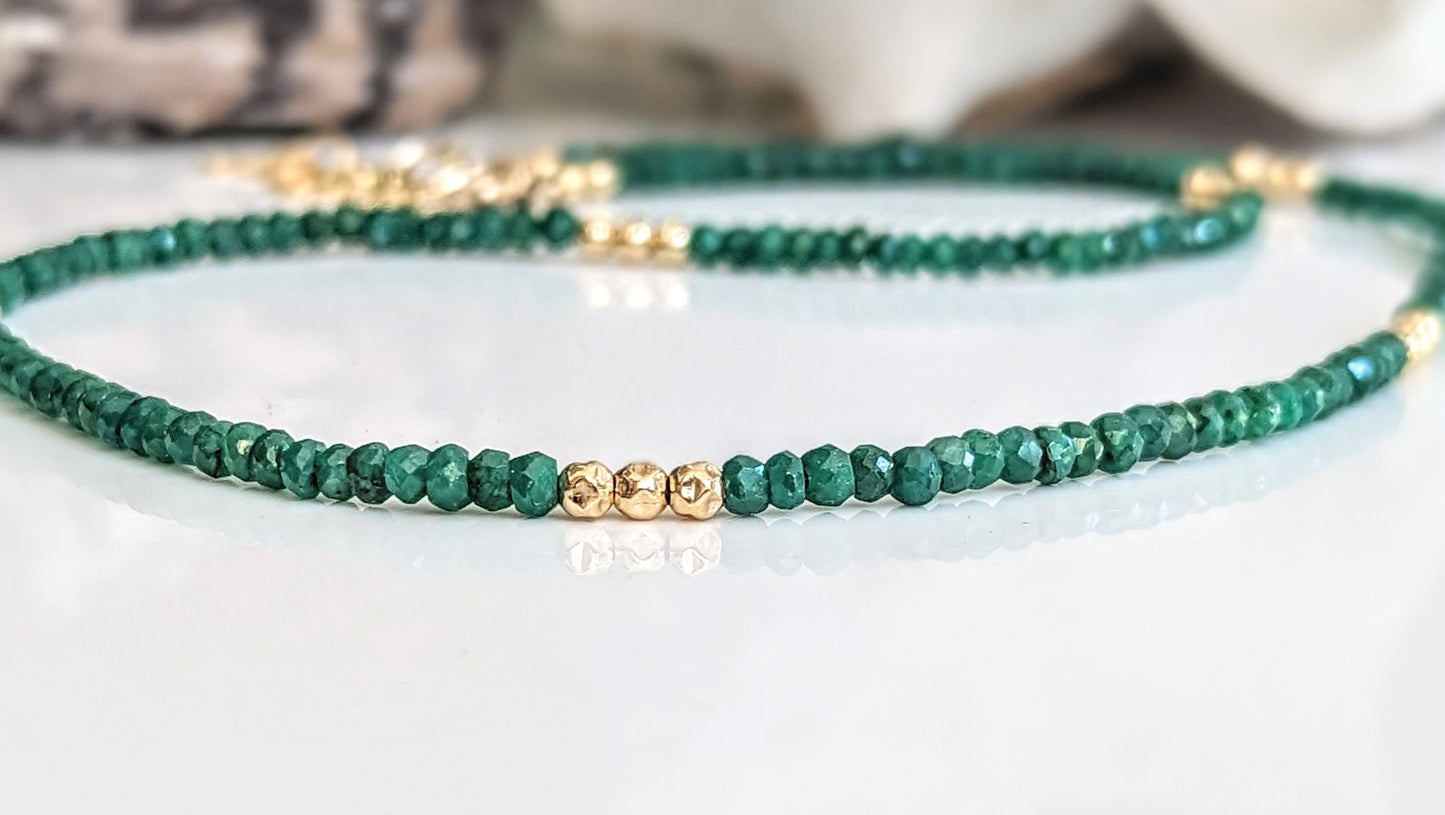 Emerald bead necklace featuring natural green beads with gold accents, symbolizing love and friendship.