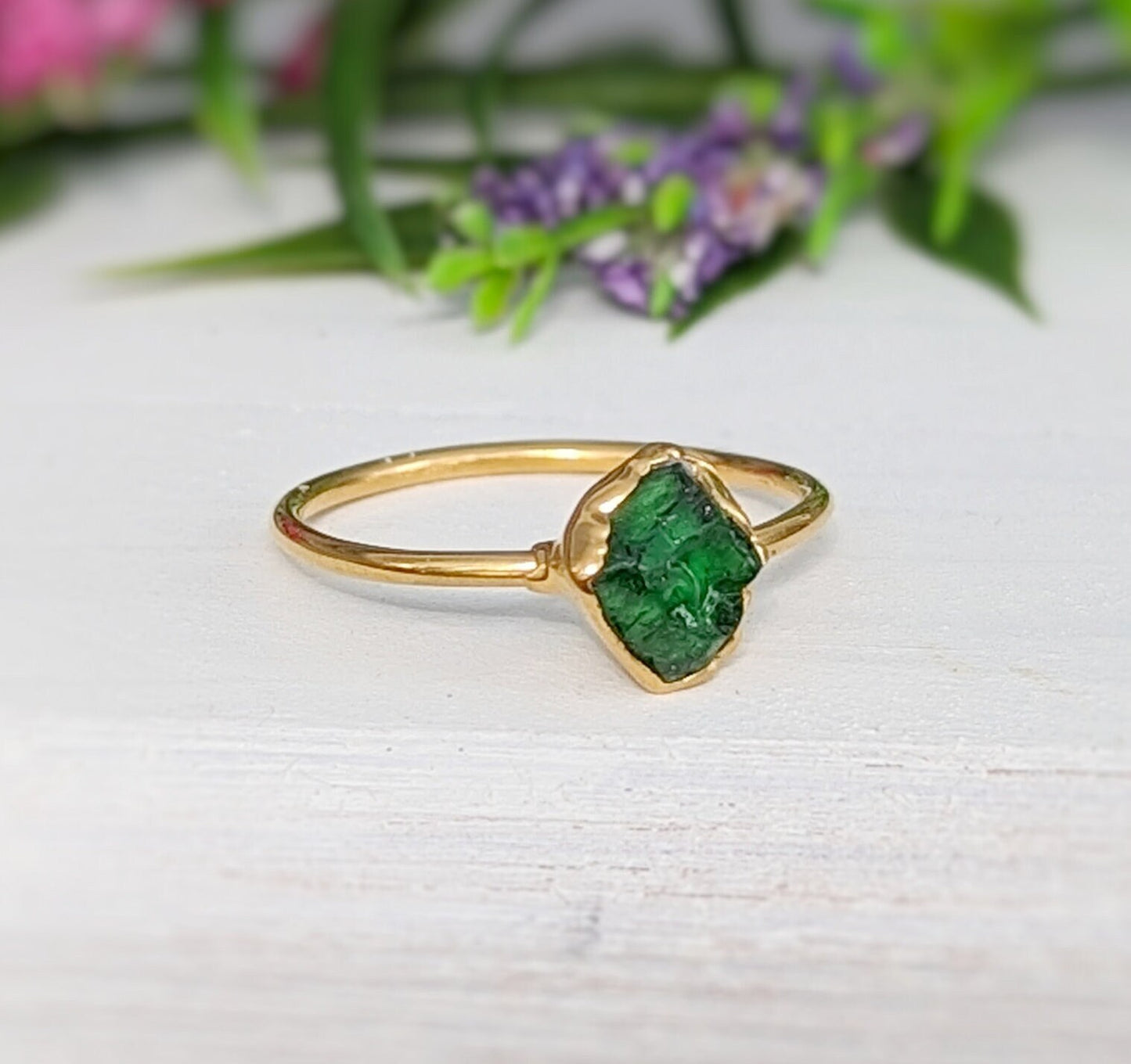 Handcrafted raw green Garnet ring with gold band, showcasing unpolished crystal beauty.