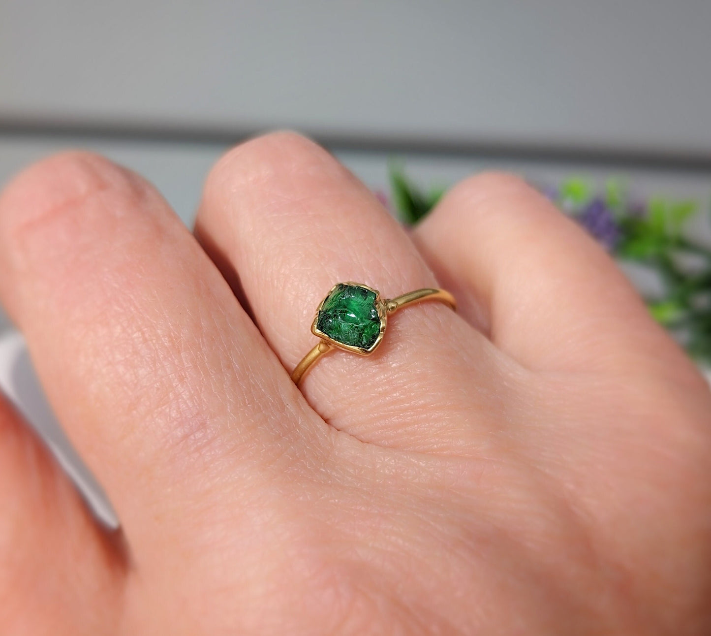 Handcrafted raw green Garnet ring on a hand, showcasing its earthy elegance and unique gemstone design.