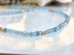 Handmade aquamarine bead necklace featuring soft blue gemstones and gold accents, symbolizing calmness and loyalty.
