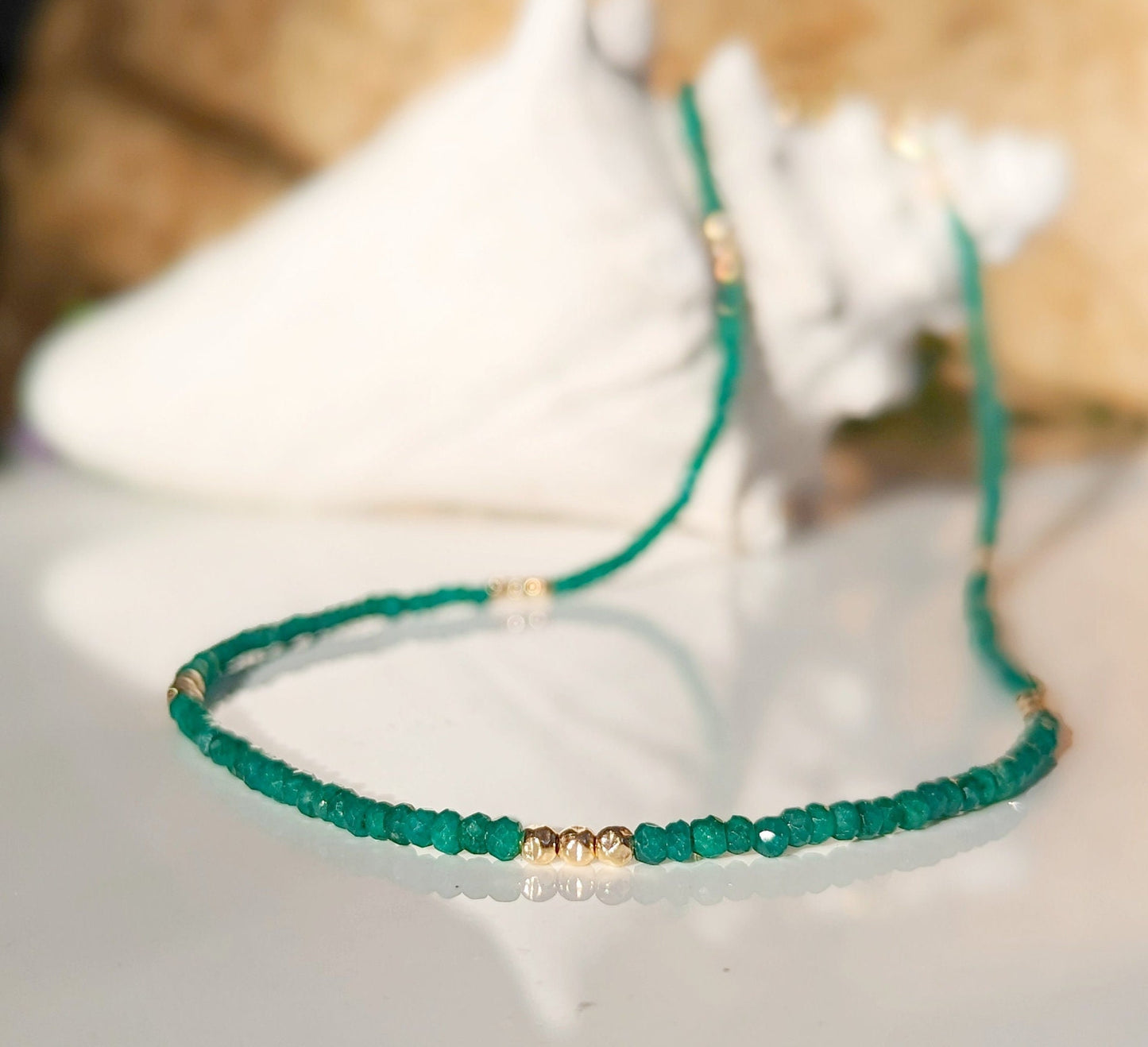 Stunning emerald bead necklace, featuring unique green beads and gold accents, perfect for love and friendship.