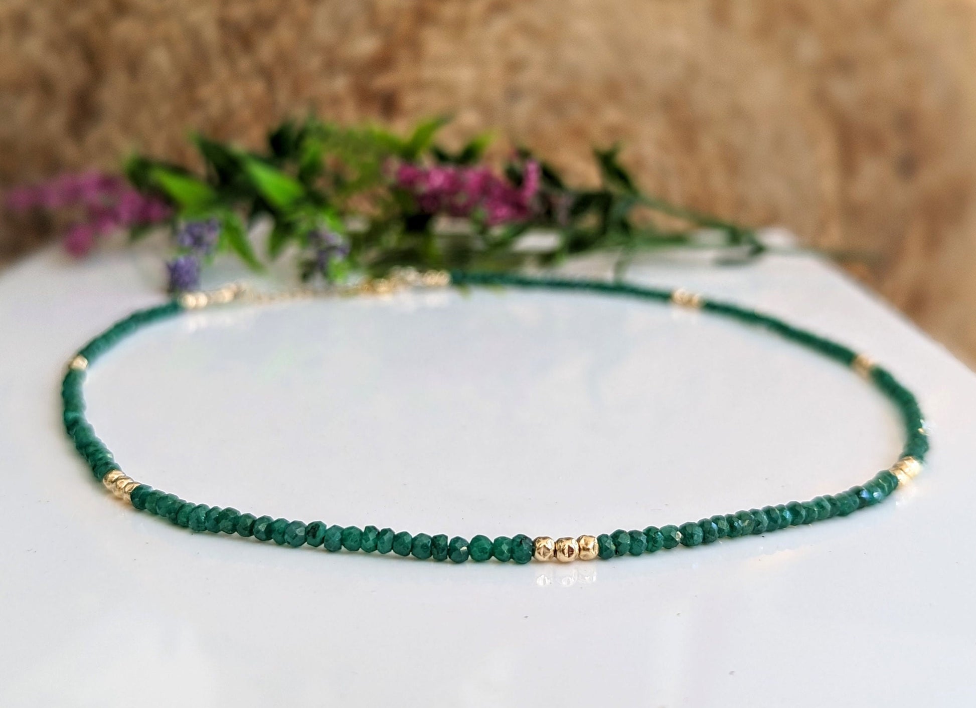 Stunning Emerald bead necklace featuring unique green beads and elegant gold accents, symbolizing love and friendship.