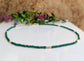 Stunning Emerald bead necklace featuring unique green beads and elegant gold accents, symbolizing love and friendship.
