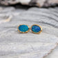 Handcrafted blue Australian opal stud earrings set in 18k gold, showcasing vibrant hues and elegant design.