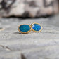 Blue Australian Opal stud earrings set in 18k Gold, showcasing vibrant blue hues and elegant design.