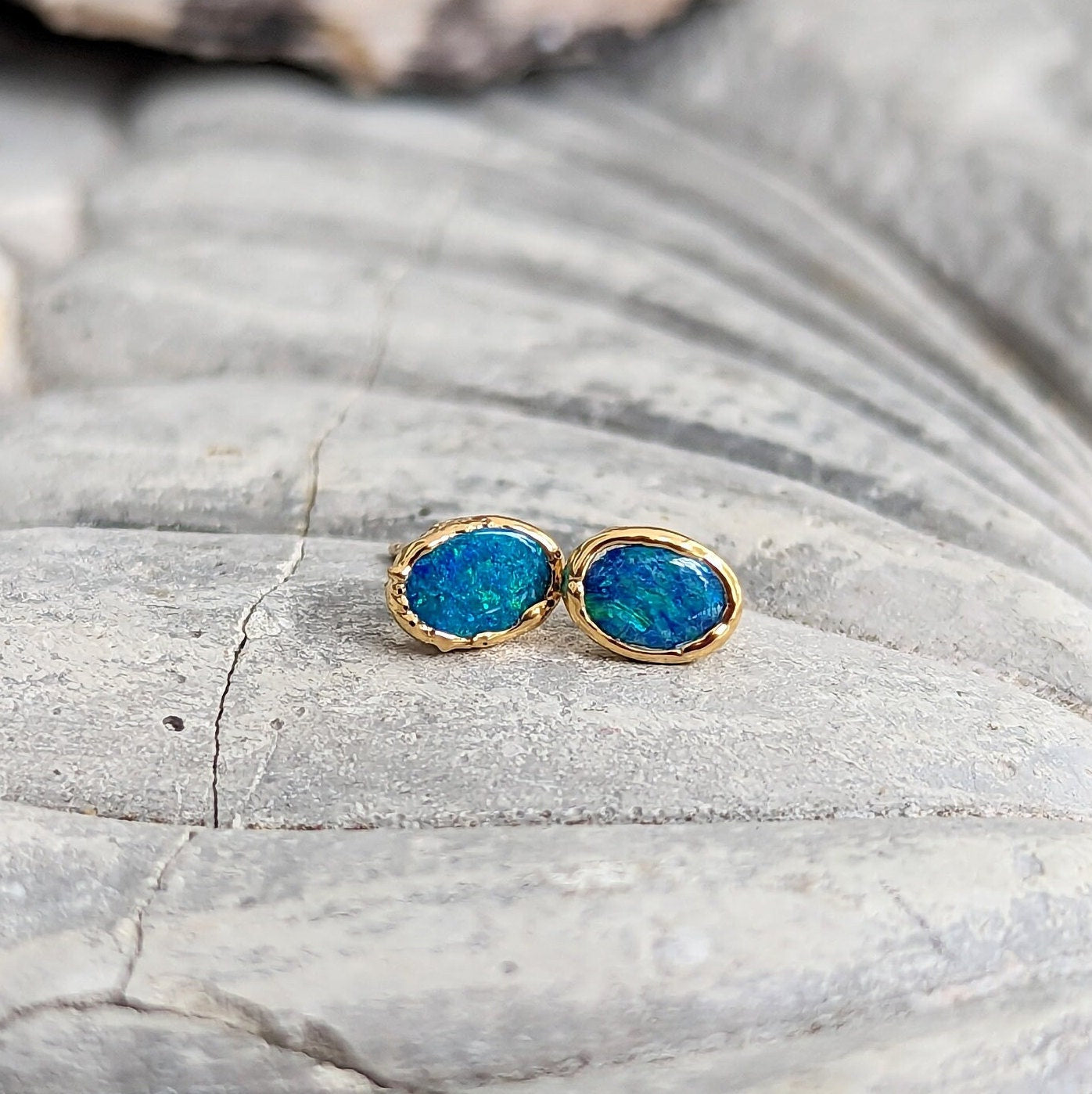 Blue Australian Opal stud earrings set in 18k Gold, showcasing elegance and vibrant hues.