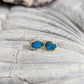 Blue Australian Opal stud earrings set in 18k Gold, showcasing elegance and vibrant hues.