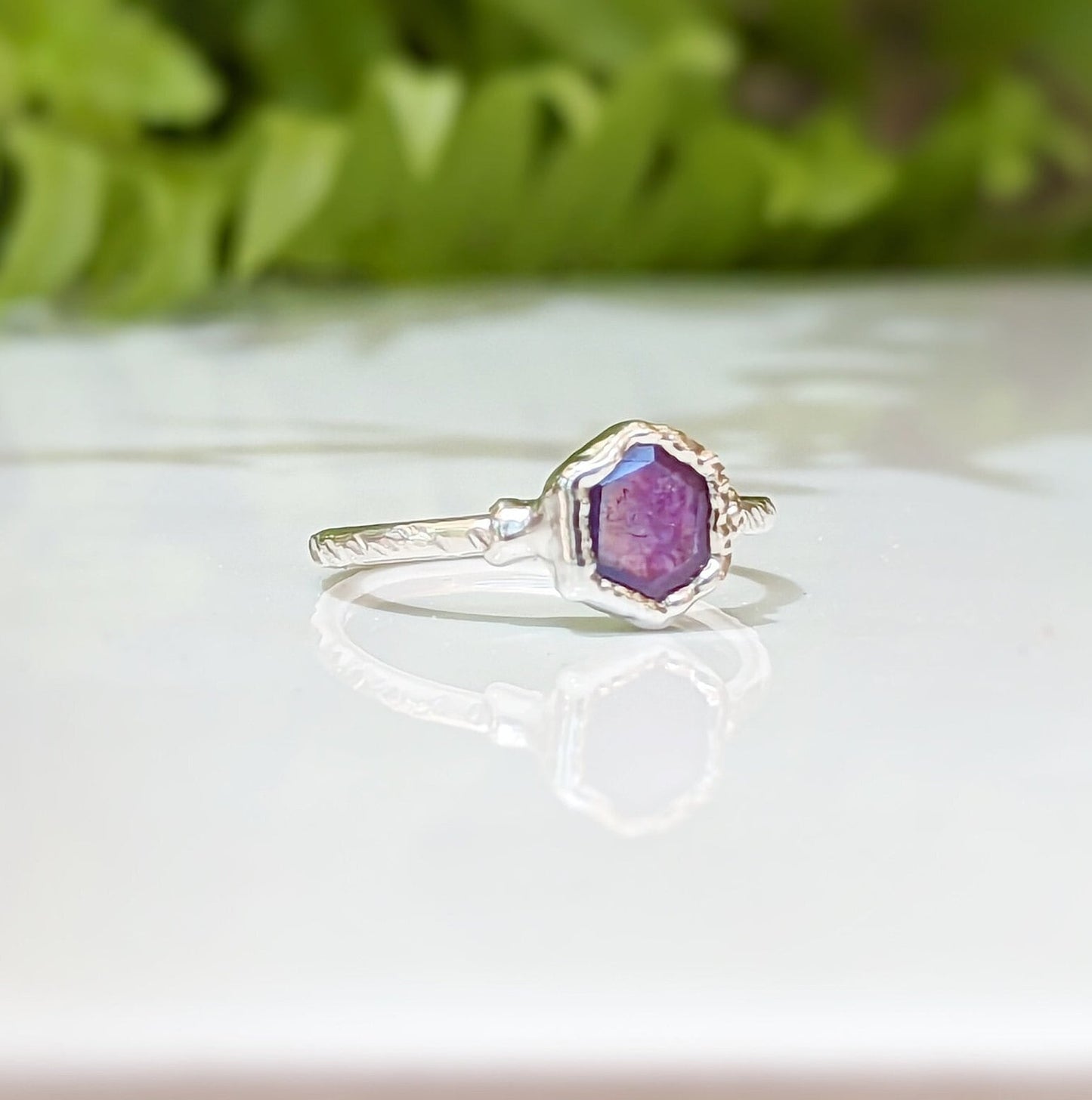 Pink Star Sapphire ring in handcrafted sterling silver, showcasing a unique natural design and vibrant colors.