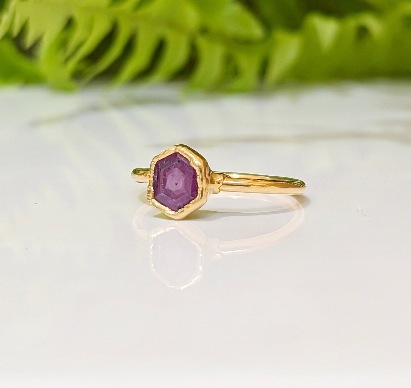 Handcrafted gold ring featuring a stunning hexagonal pink sapphire, perfect for unique gifts and special occasions.