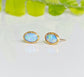 Light blue Australian Opal stud earrings in gold settings, perfect for weddings and special occasions.