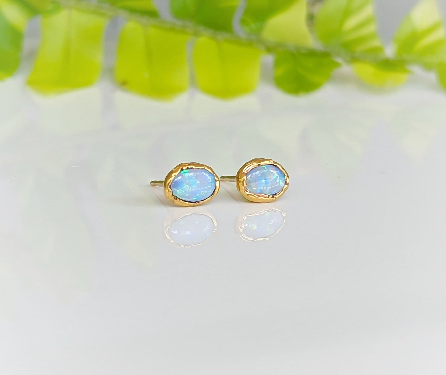 Light blue Australian Opal stud earrings on 14k gold filled posts, reflecting elegance and sophistication.