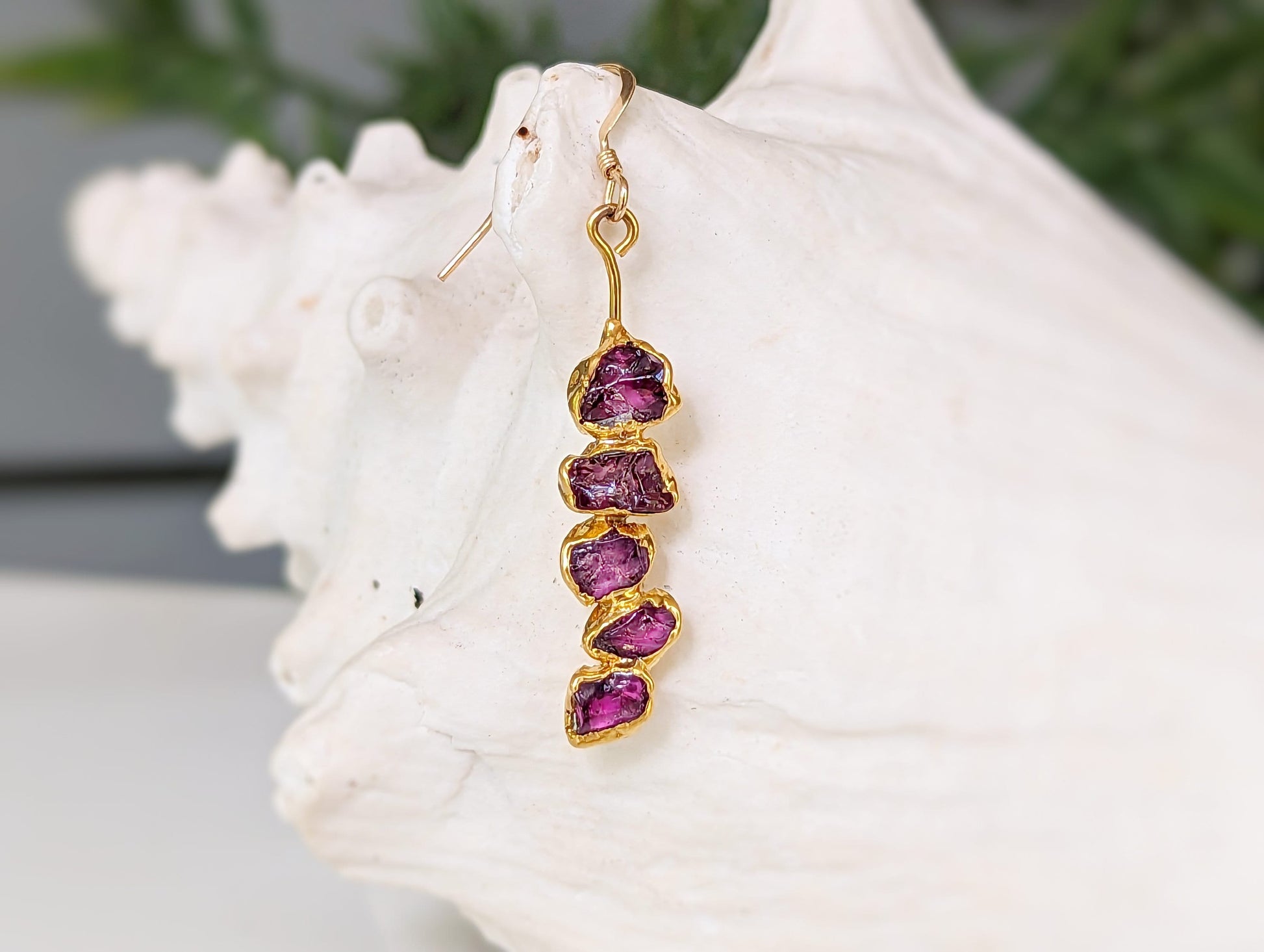 Rhodolite Garnet dangle earrings showcasing raw raspberry pink gemstones in a unique gold design, perfect for special occasions.