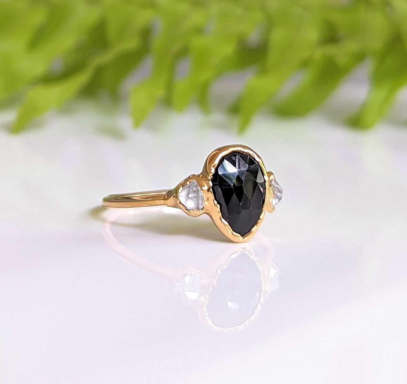 Black Spinel engagement ring with Herkimer diamonds in 18k gold, showcasing unique dark elegance and handcrafted design.