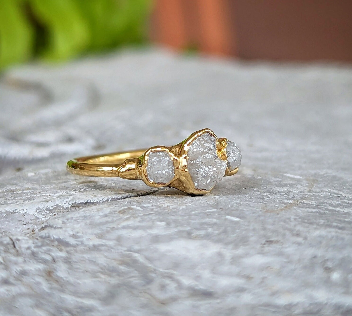 Raw multi diamond engagement ring featuring uncut diamonds on a solid gold band, perfect for unique proposals.