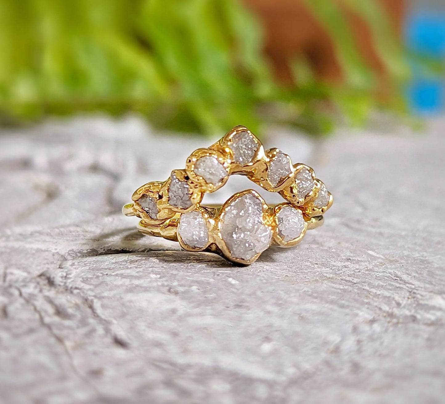 Raw diamond wedding ring set in solid 18k gold, showcasing unique rustic design and shimmering diamonds.