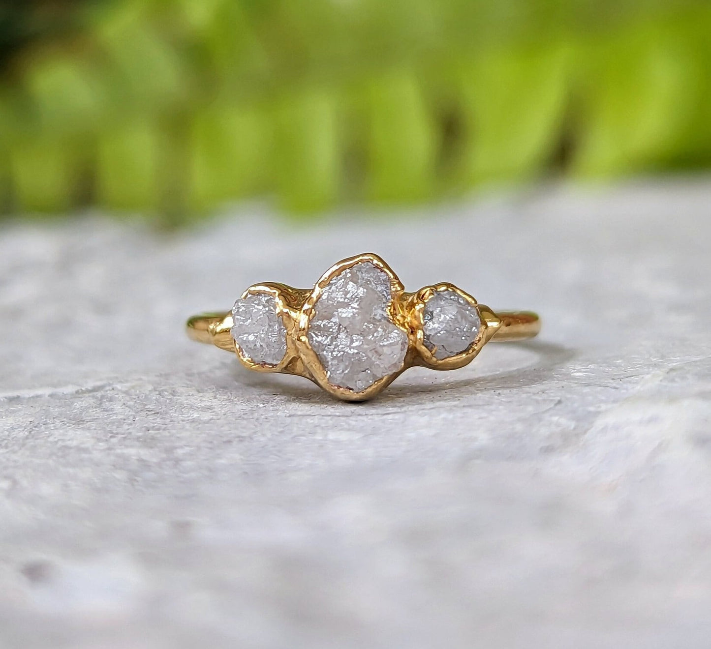 Raw diamond ring set in solid 18k gold featuring three unique raw diamonds for an elegant bridal look.