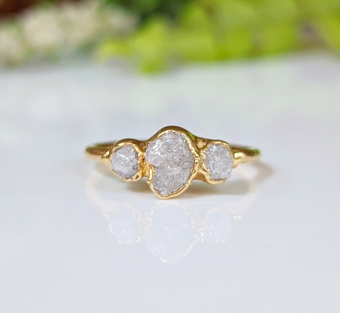 Raw multi diamond engagement ring with handcrafted gold band and three unique rough diamonds.