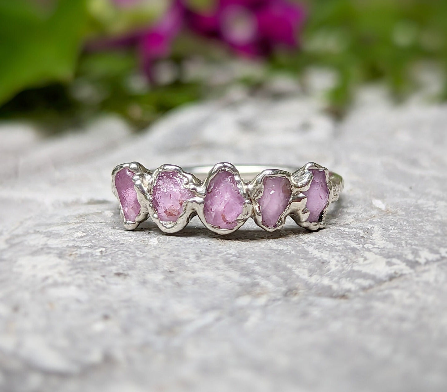 Raw pink Sapphire Eternity ring with 5-7 small sapphires on handcrafted Sterling Silver band.