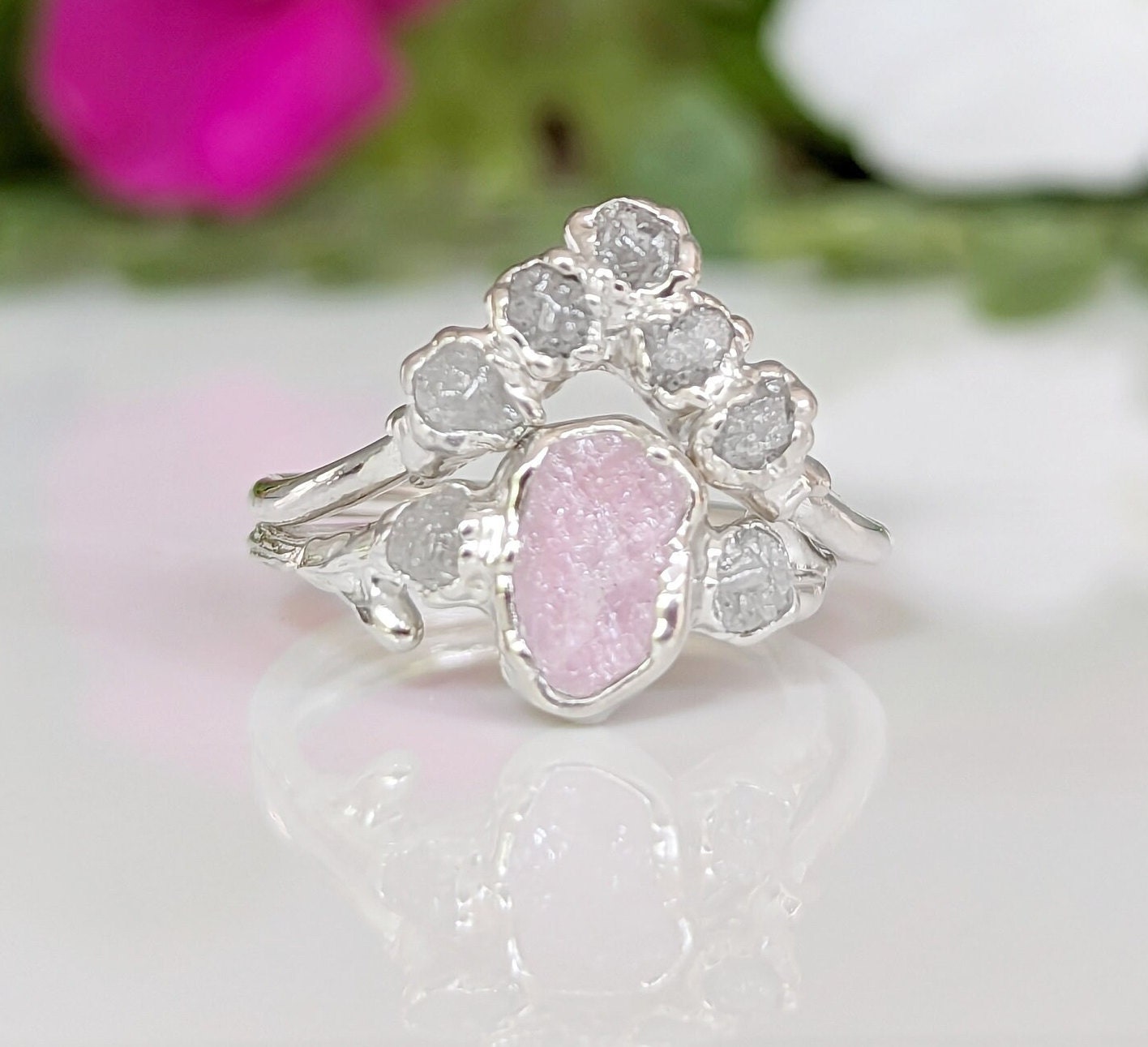 Raw pink Morganite and diamond wedding ring set on a silver band, featuring unique twig design and sparkly Chevron accents.