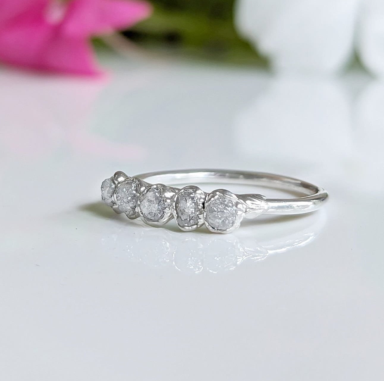 Silver raw diamond wedding band featuring five small raw diamonds in a rustic elegant design.