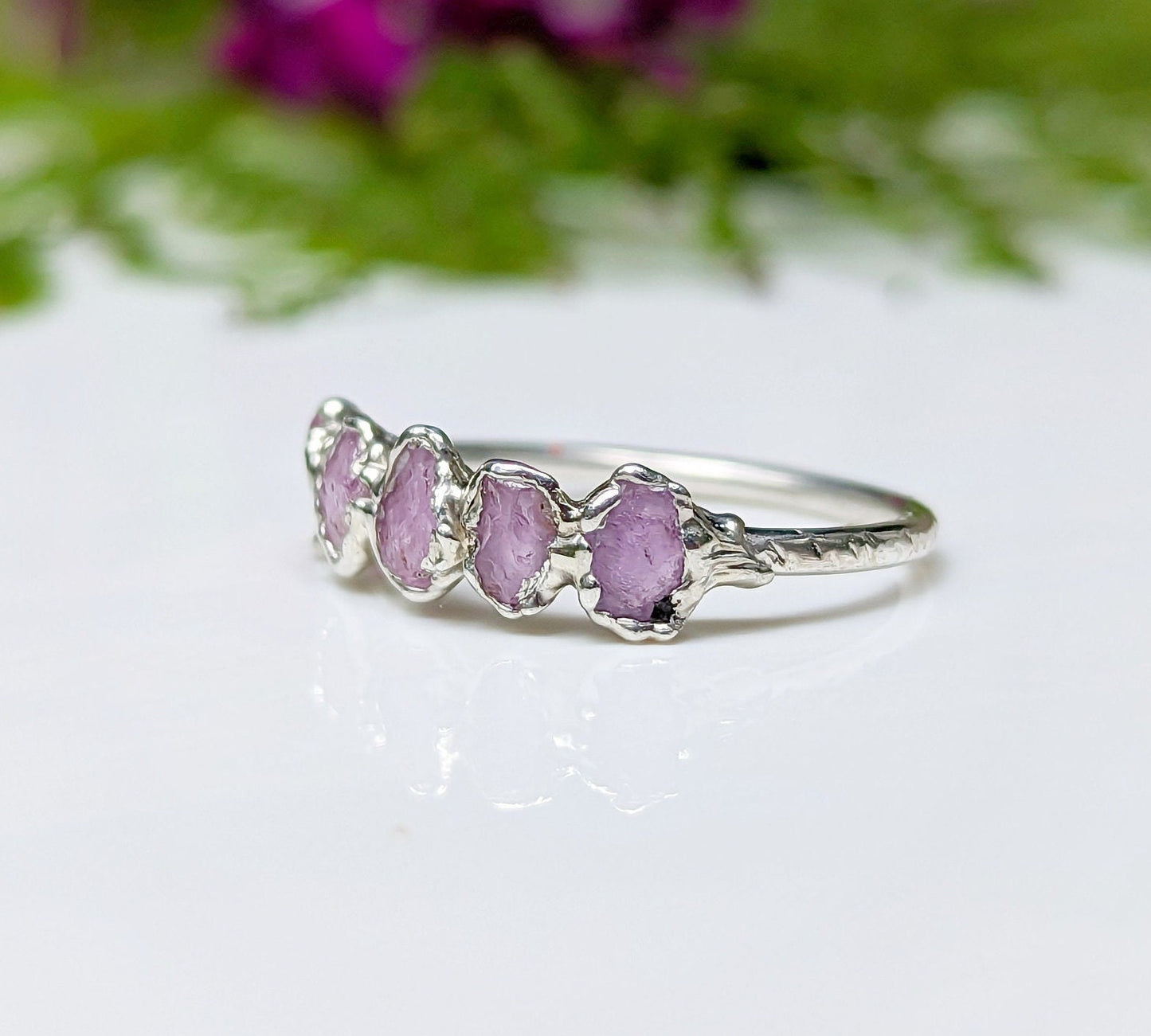 Handcrafted raw pink Sapphire Eternity ring on a silver band, featuring 5-7 raw pink sapphires.