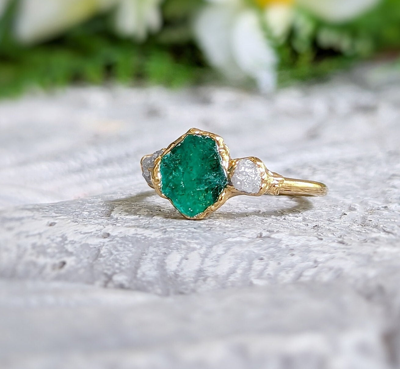 Raw emerald and diamond chevron bridal ring set on gold band, ideal for nature lovers.