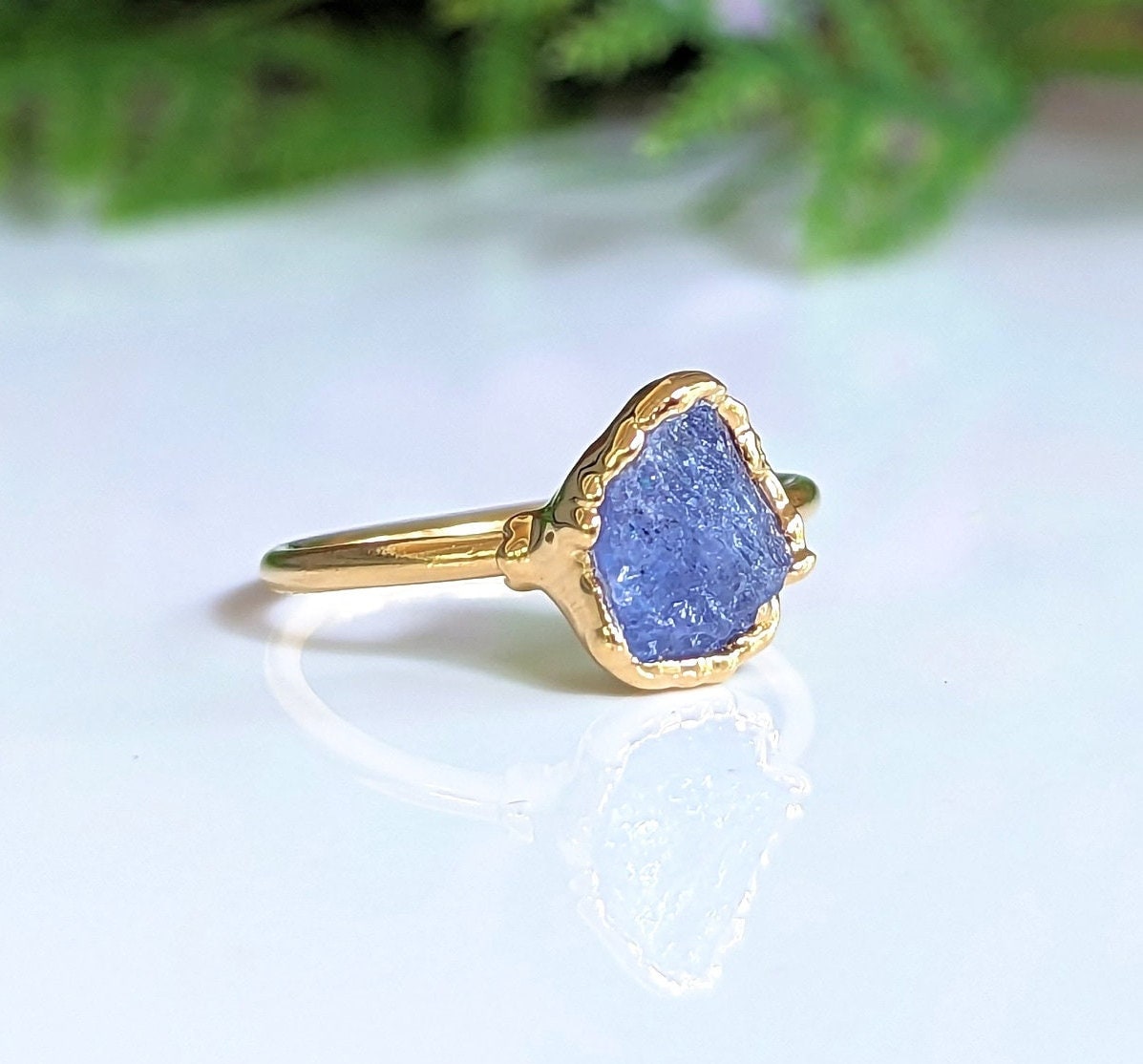 Raw Tanzanite ring in 18k gold, featuring a rustic yet elegant design, perfect for special occasions.