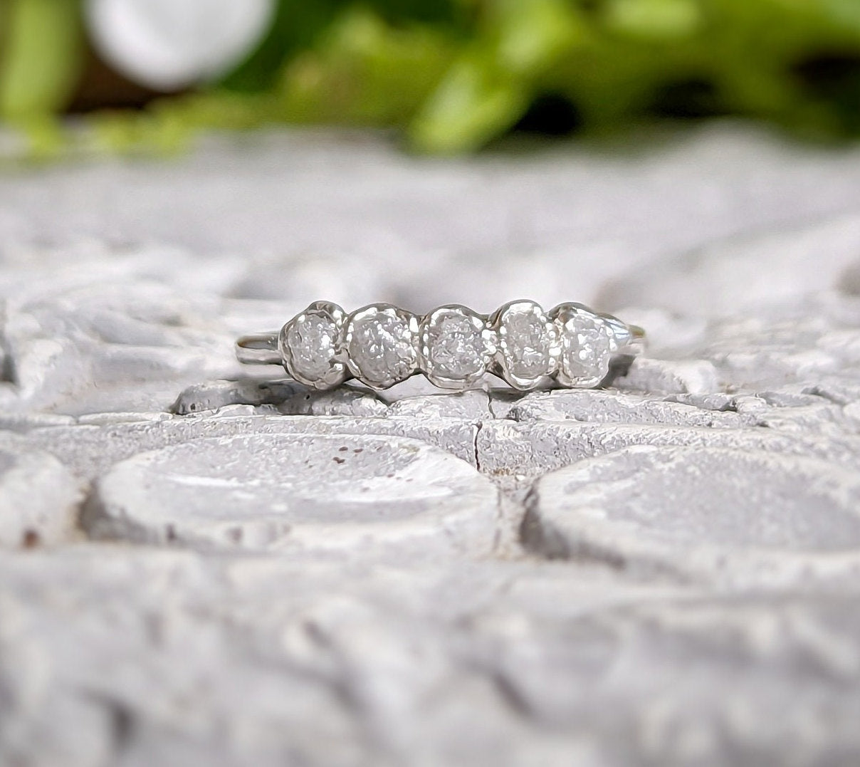 Raw diamond wedding band in sterling silver featuring five small conflict-free diamonds, showcasing a rustic elegance.