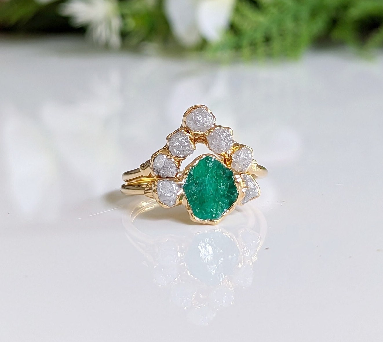 Raw emerald and diamond chevron bridal ring set on a gold band, perfect for nature lovers.