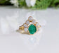 Raw emerald and diamond chevron bridal ring set on a gold band, perfect for nature lovers.