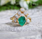 Raw emerald and diamond Chevron bridal ring set on an 18k gold band, elegant and unique wedding jewelry.