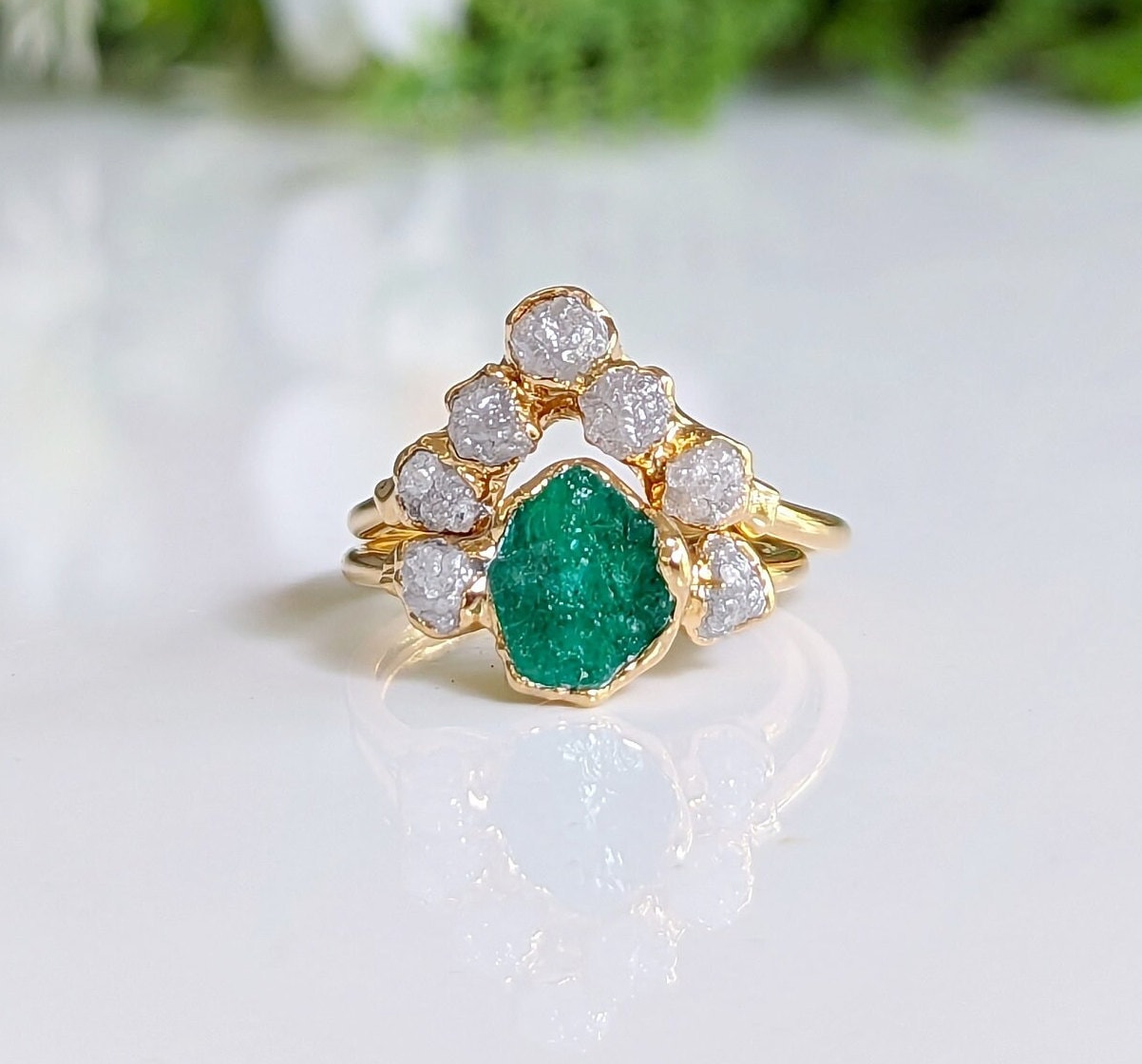 Raw emerald and diamond Chevron bridal ring set on a gold band, perfect for nature lovers.