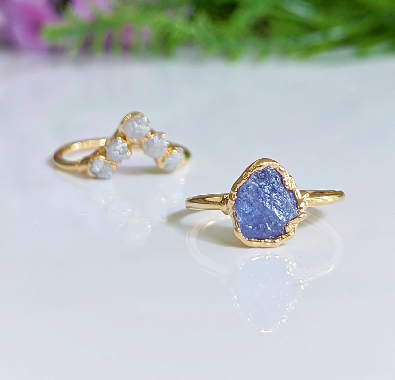 Raw Tanzanite and diamond Chevron wedding ring set on gold bands, showcasing unique bridal jewelry.