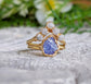 Raw Tanzanite and diamond Chevron wedding ring set on a gold band, showcasing a unique and eye-catching design.