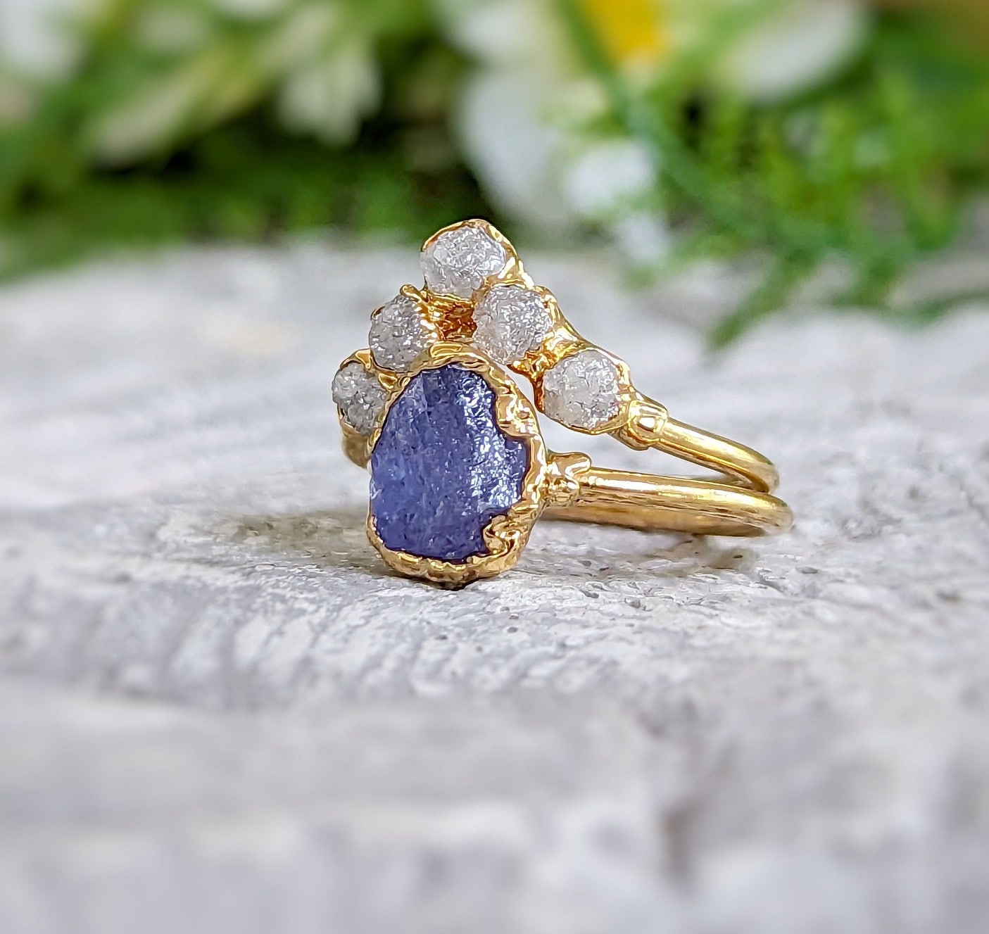 Raw Tanzanite and diamond Chevron wedding ring set on a golden band, showcasing unique handcrafted design.