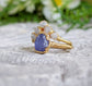 Raw Tanzanite and diamond Chevron wedding ring set on a golden band, showcasing unique handcrafted design.