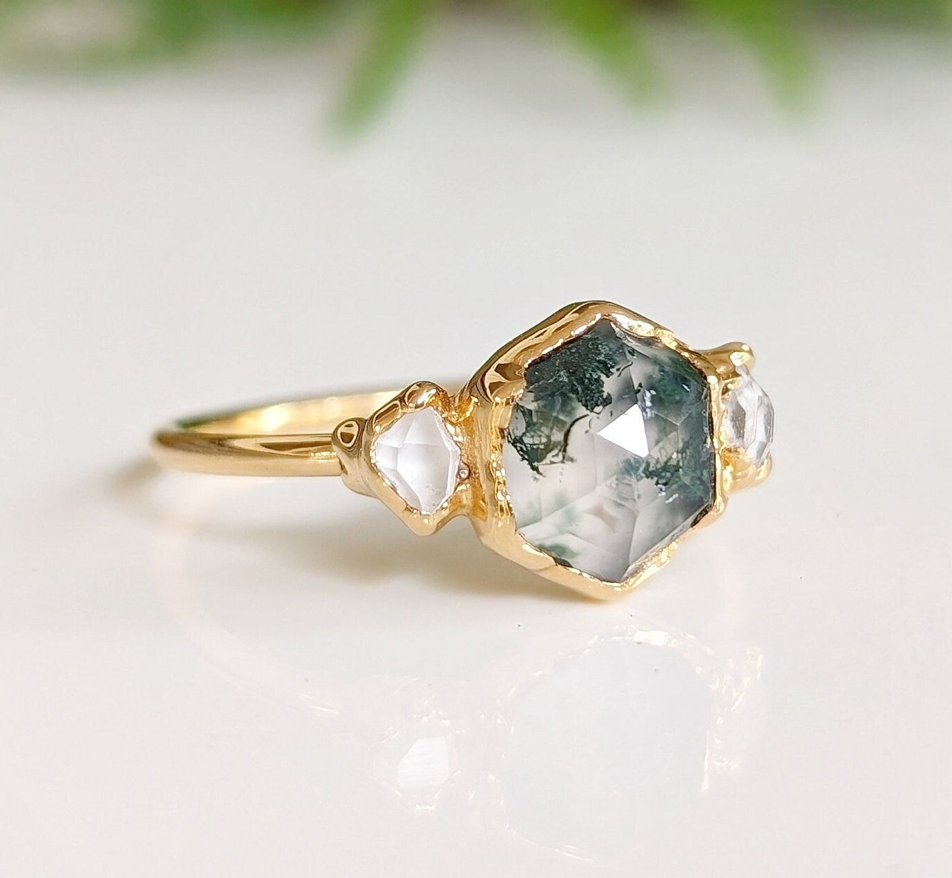 Hexagon-shaped Moss Agate engagement ring with raw Herkimer diamonds on a 14k gold band.