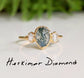 Moss Agate and Herkimer diamond engagement ring on gold band, featuring pear shape Moss Agate and raw Herkimer diamonds.