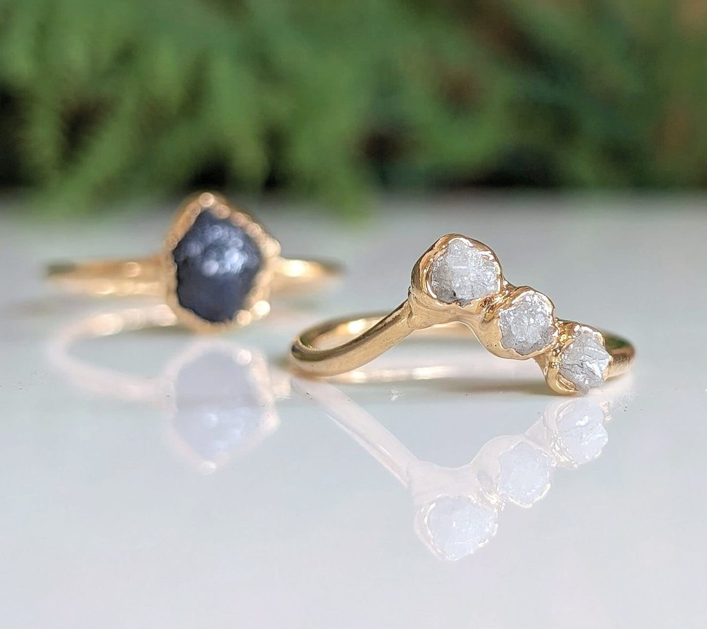 Raw sapphire and diamond wedding rings in gold settings, showcasing unique rustic designs perfect for nature lovers.