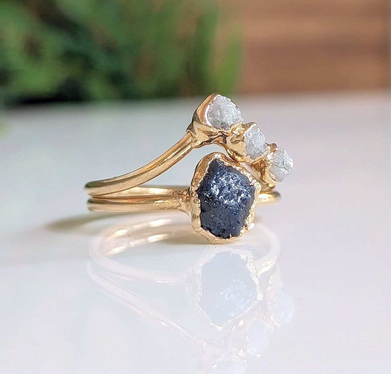 Raw sapphire and diamond wedding ring set with 14k gold bands, showcasing a unique chevron design.