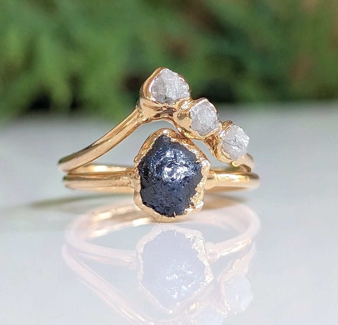 Unique raw sapphire and diamond wedding ring set on solid 14k gold bands, showcasing rustic elegance and nature-inspired design.