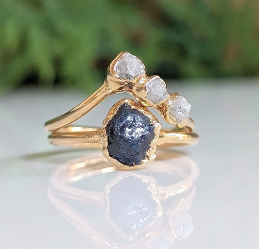 Unique raw sapphire and diamond wedding ring set on solid 14k gold bands, showcasing rustic elegance and nature-inspired design.
