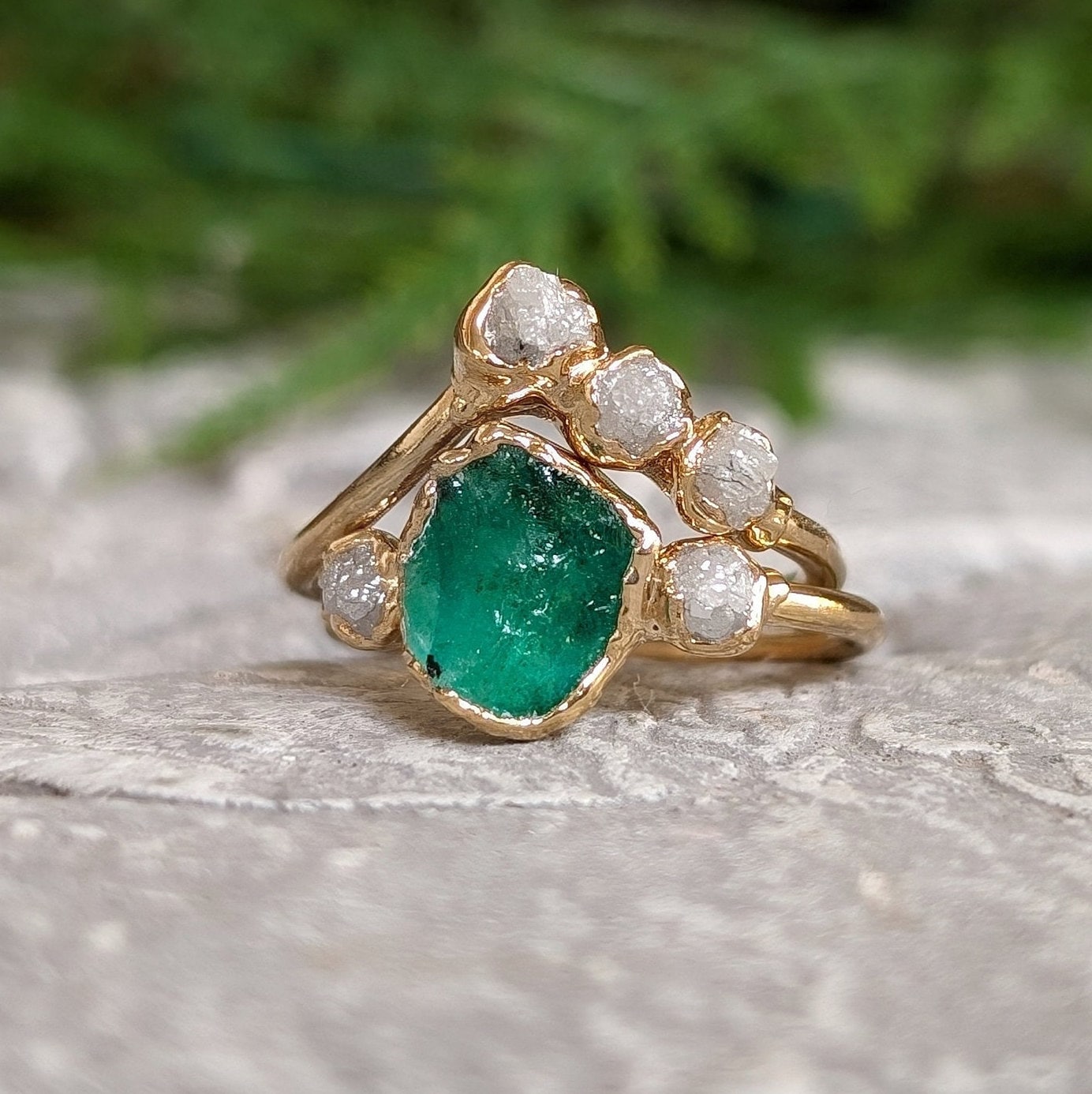 Raw emerald and rough diamond Chevron wedding ring set on an 18k gold band, perfect for nature lovers.