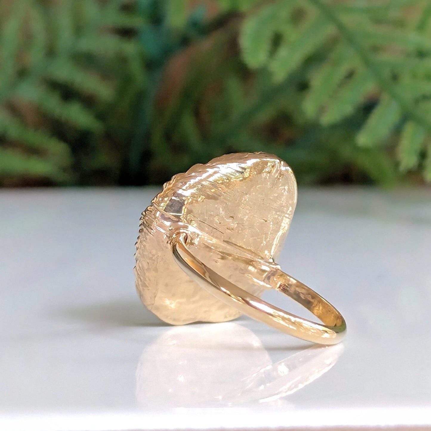 Handcrafted Mother of Pearl Kintsugi ring on a gold-filled band, showcasing unique artisanal design and elegance.